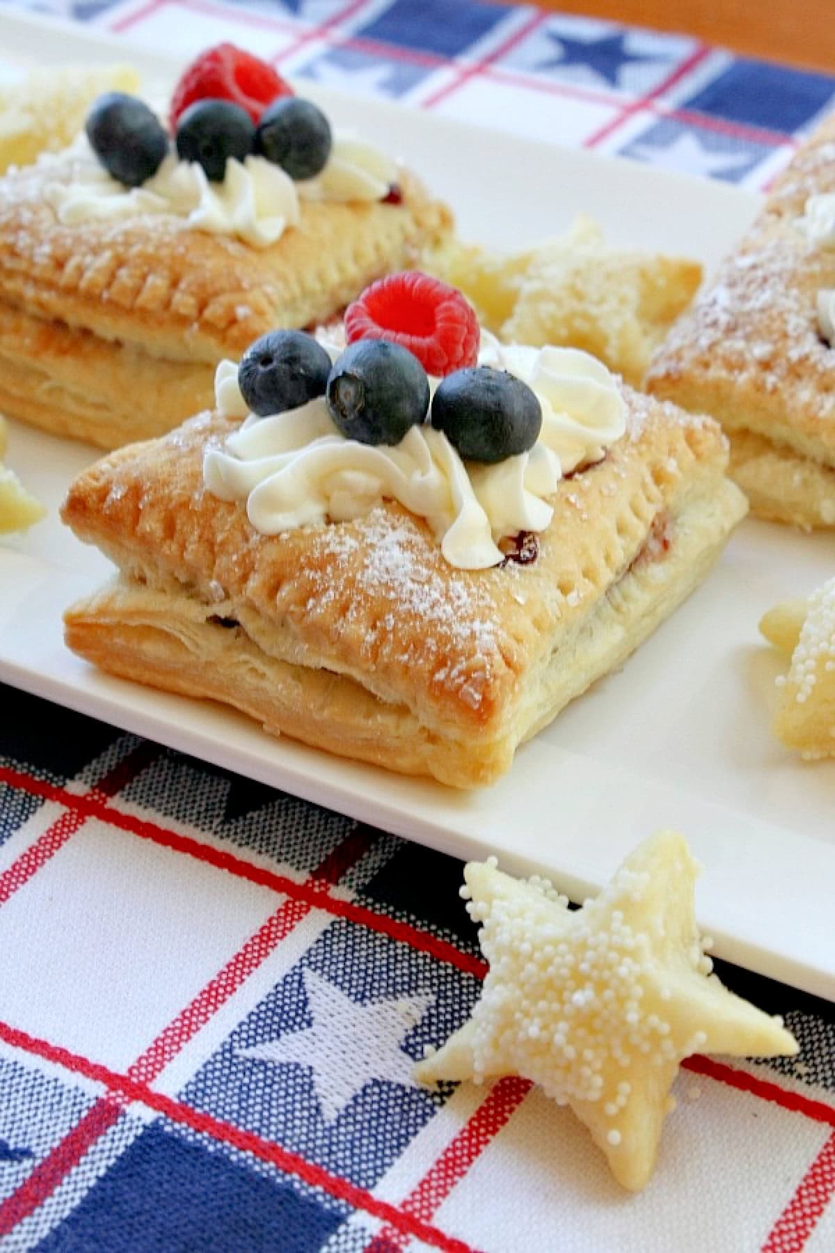Red, White and Blue Patriotic Pastries recipe from RecipeGirl.com red white and blue pastries on white plate
