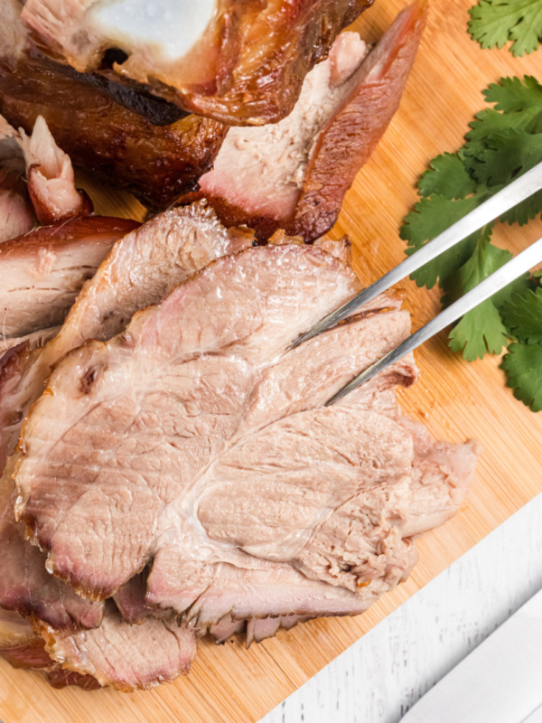 serving fork with slices of sangria roasted pork