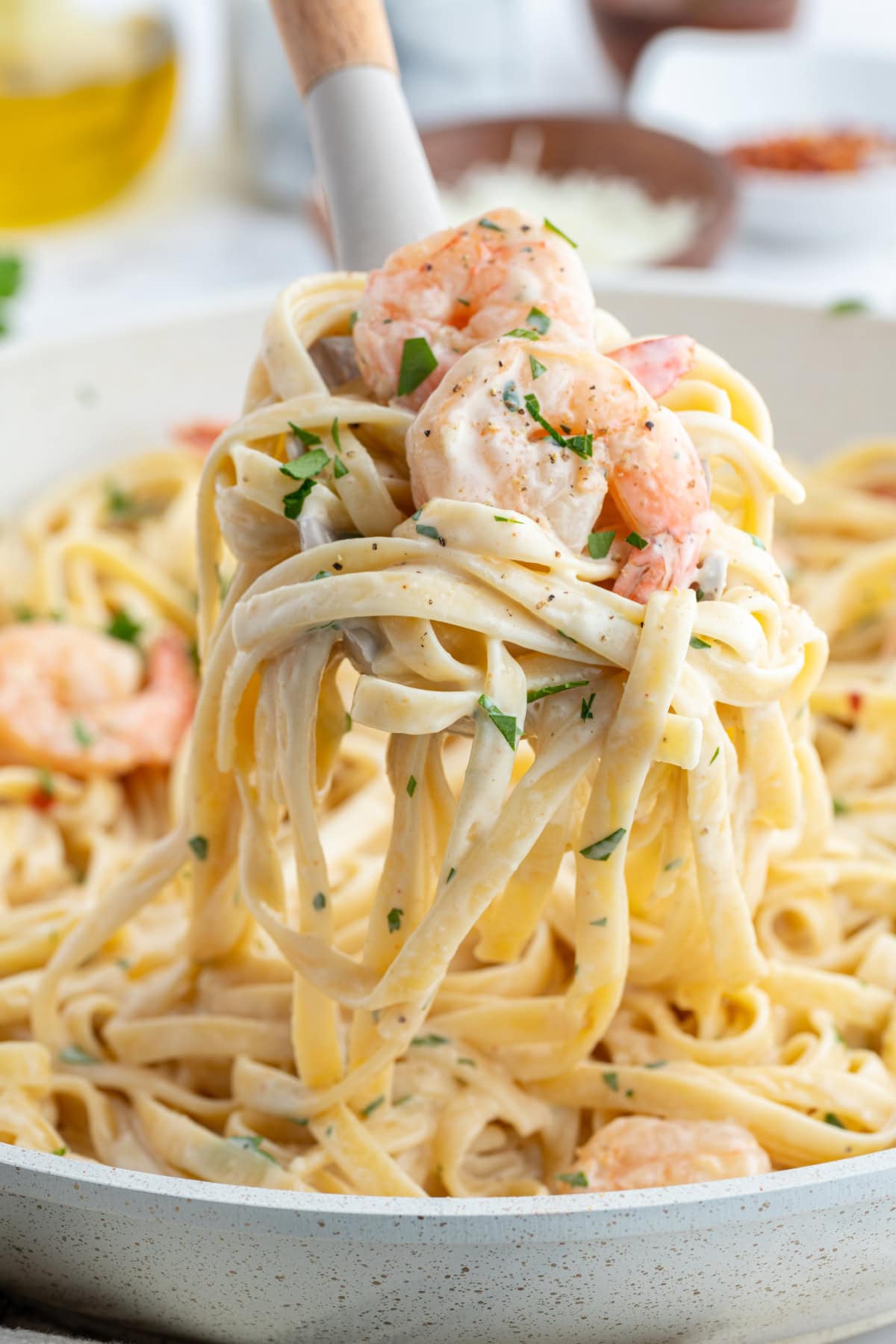 Shrimp Scampi Alfredo recipe from RecipeGirl.com big fork full of shrimp scampi alfredo
