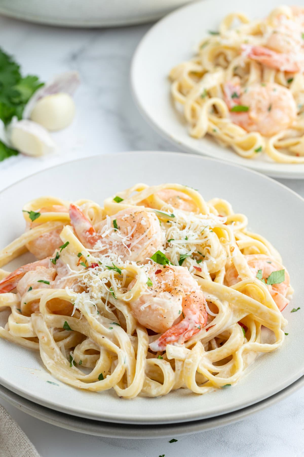 Shrimp Scampi Alfredo recipe from RecipeGirl.com serving of shrimp scampi alfredo on plate with parmesan on top