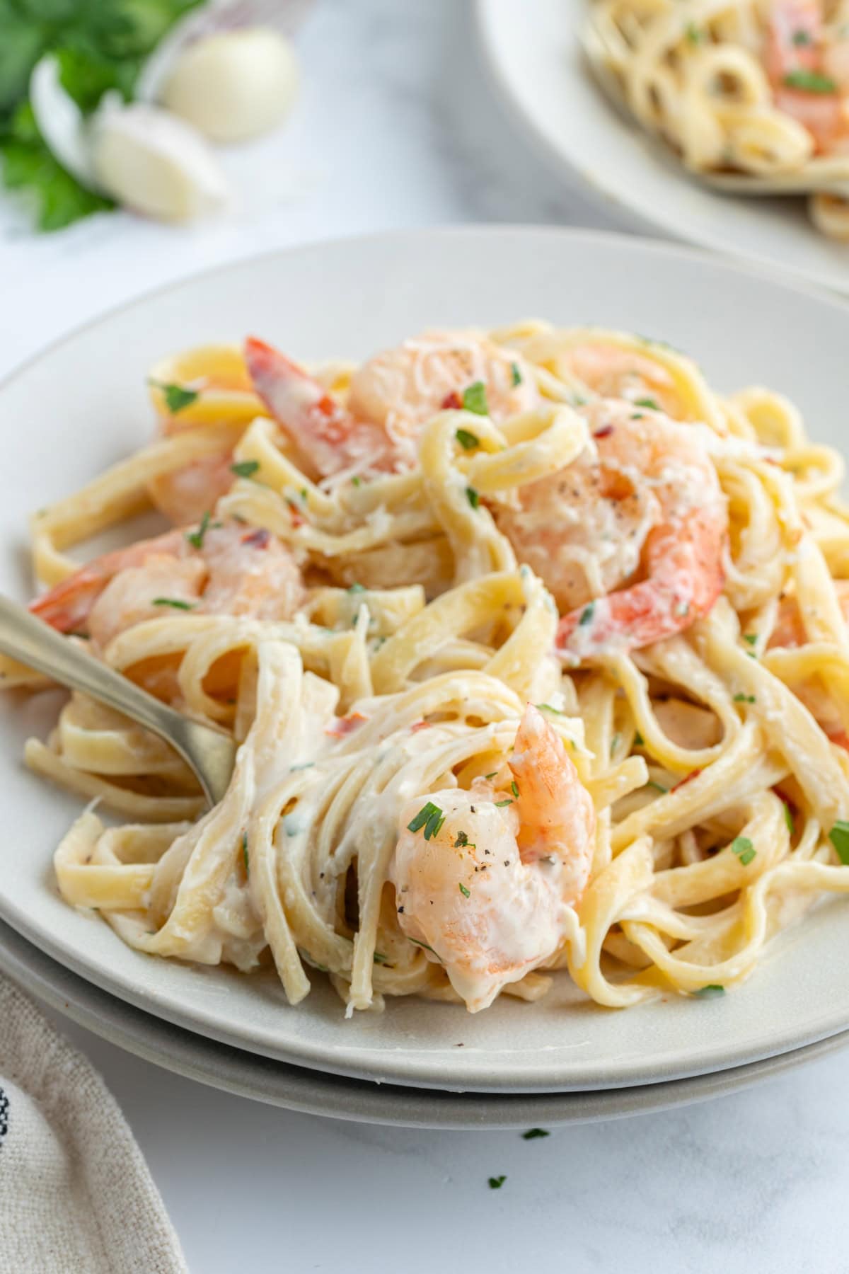 Shrimp Scampi Alfredo recipe from RecipeGirl.com serving of shrimp scampi alfredo on plate