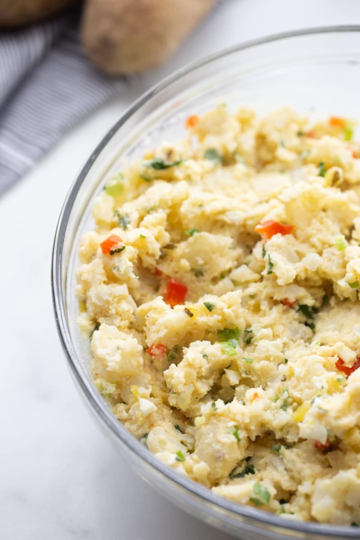 21 Favorite Potato Salad Recipes collection on RecipeGirl.com bowl of smashed potato salad in bowl