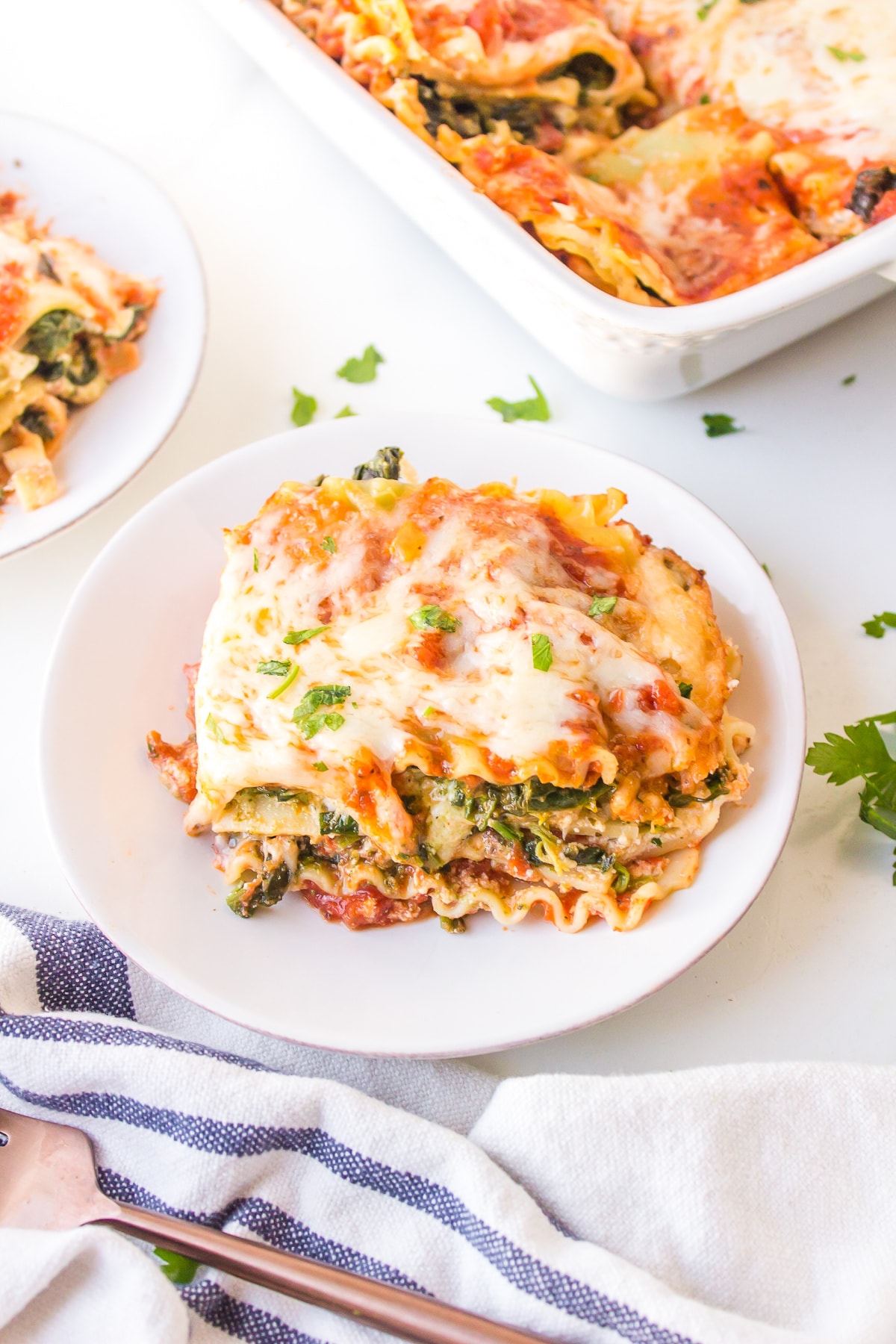 Spinach, Pesto and Cheese Lasagna recipe from RecipeGirl.com serving of lasagna on plate