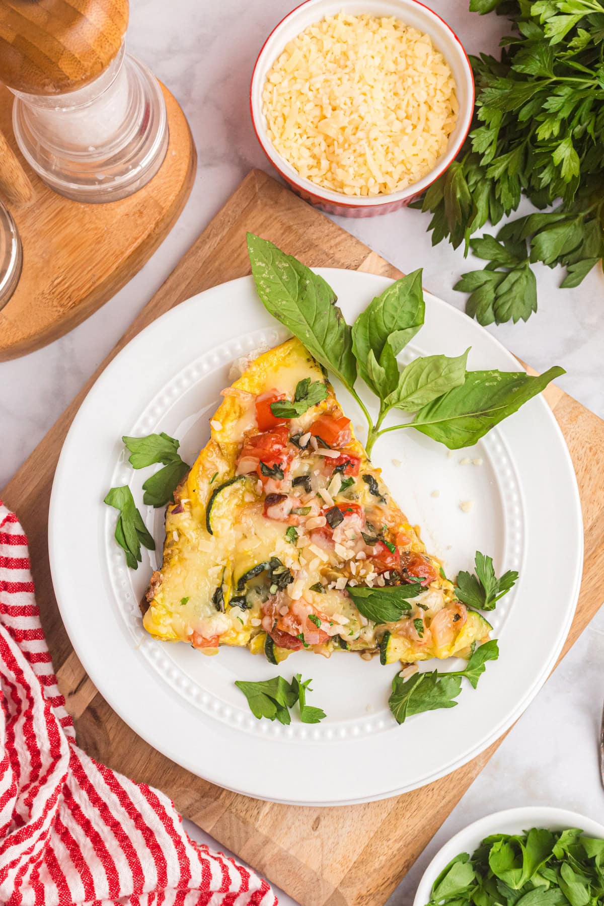 Squash and Tomato Oven Frittata recipe from RecipeGirl.com slice of squash and tomato oven frittata on plate