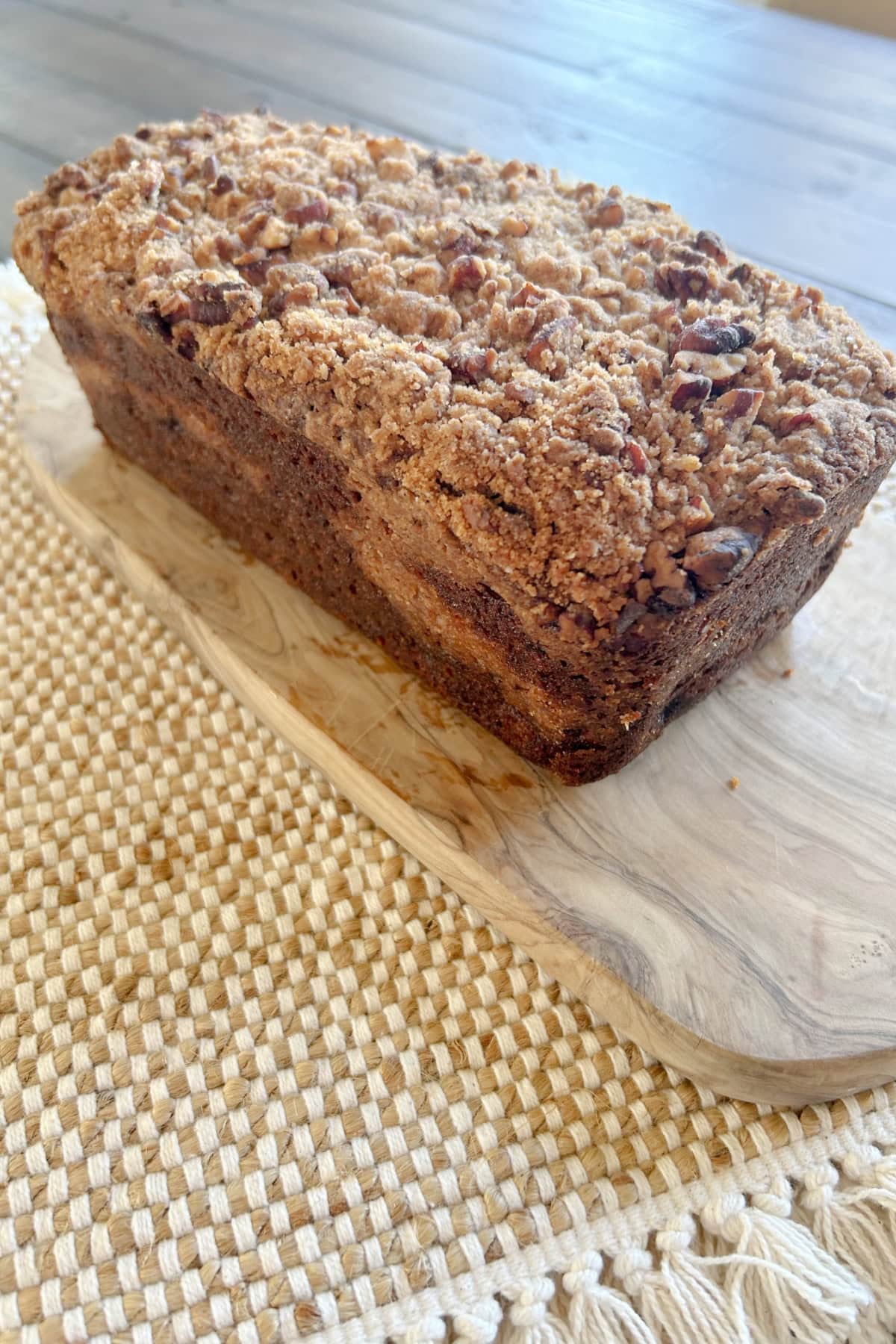 Streusel Banana Bread recipe from RecipeGirl.com loaf of streusel banana bread sitting on bread board