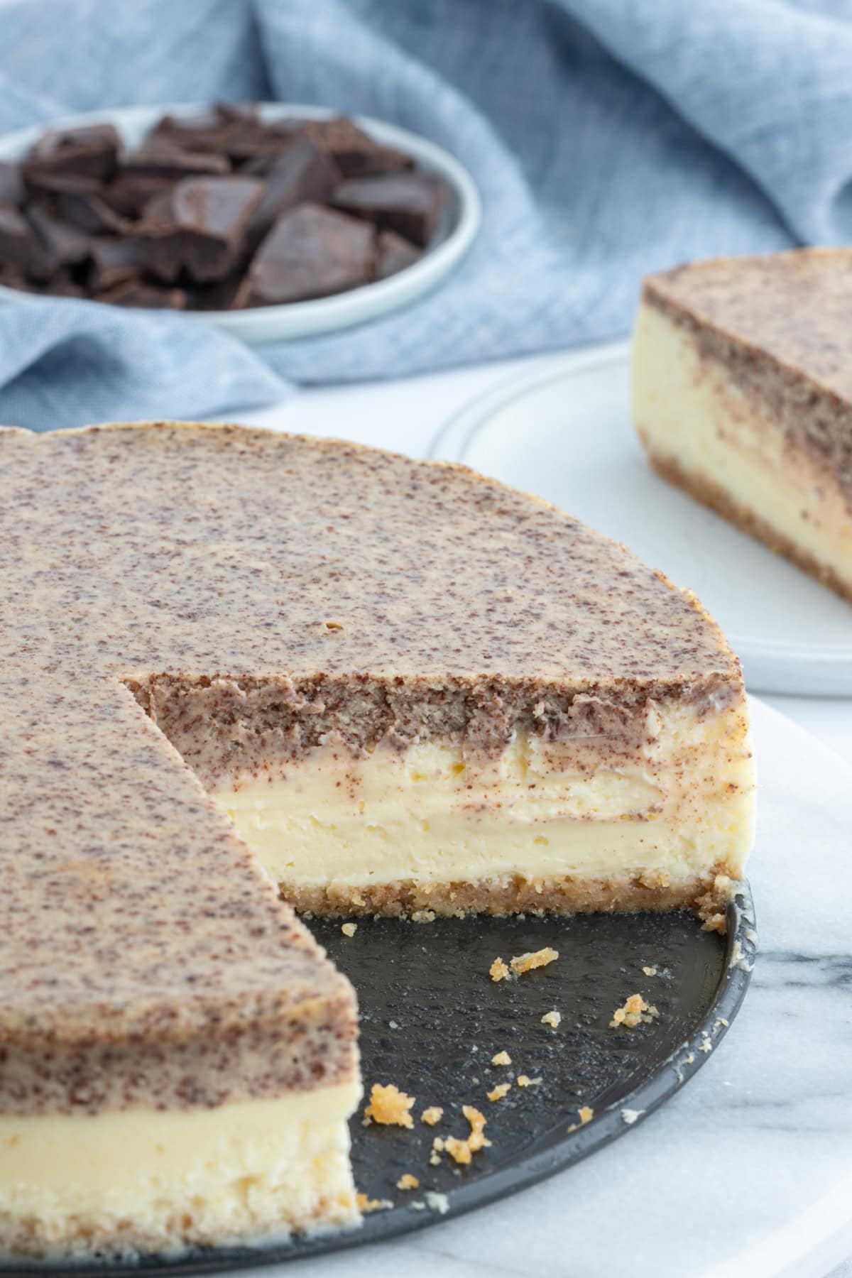 Tiramisu Cheesecake recipe from RecipeGirl.com tiramisu cheesecake with large slice taken out of it