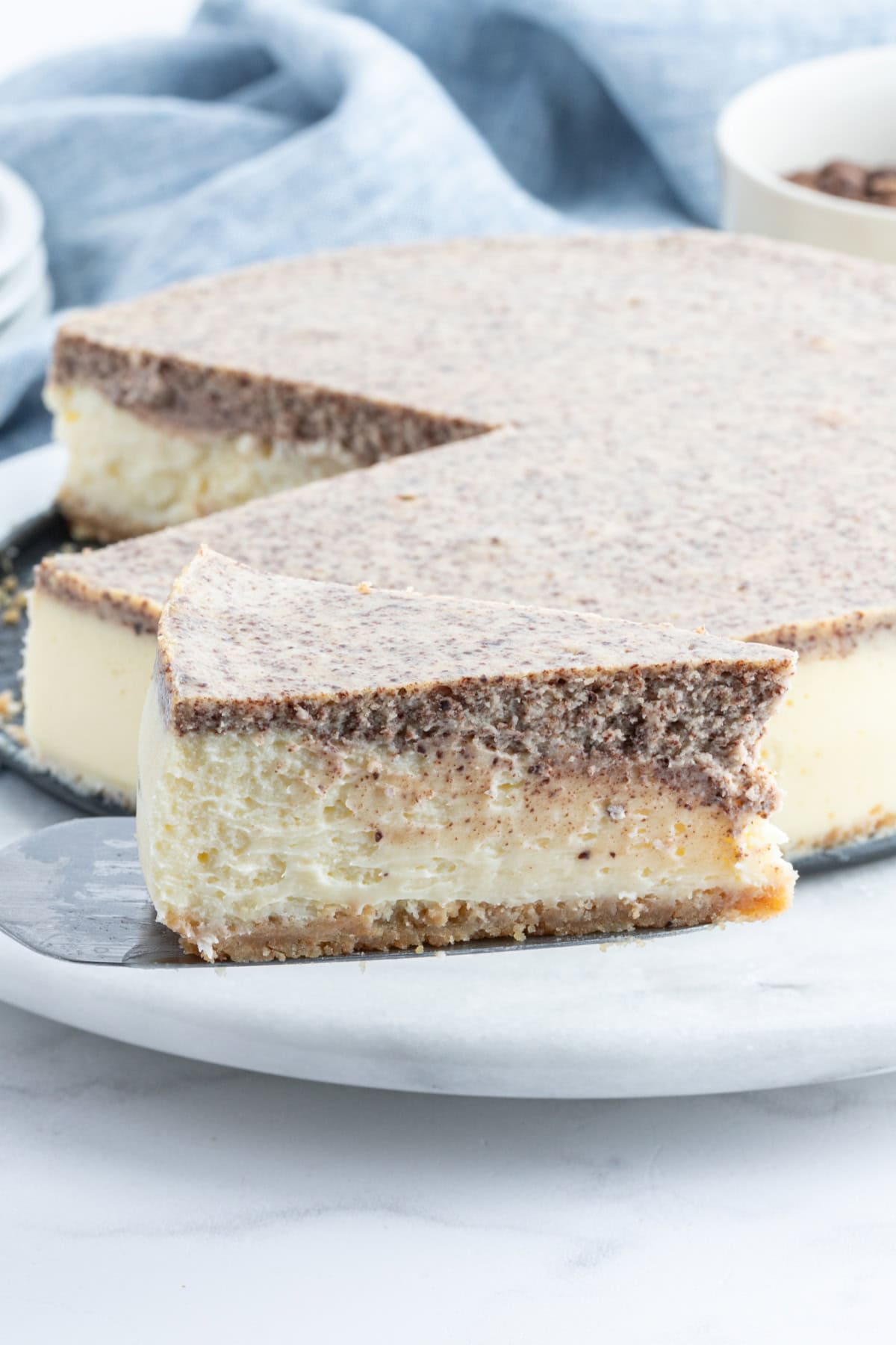 Tiramisu Cheesecake recipe from RecipeGirl.com spatula taking out slice of tiramisu cheesecake